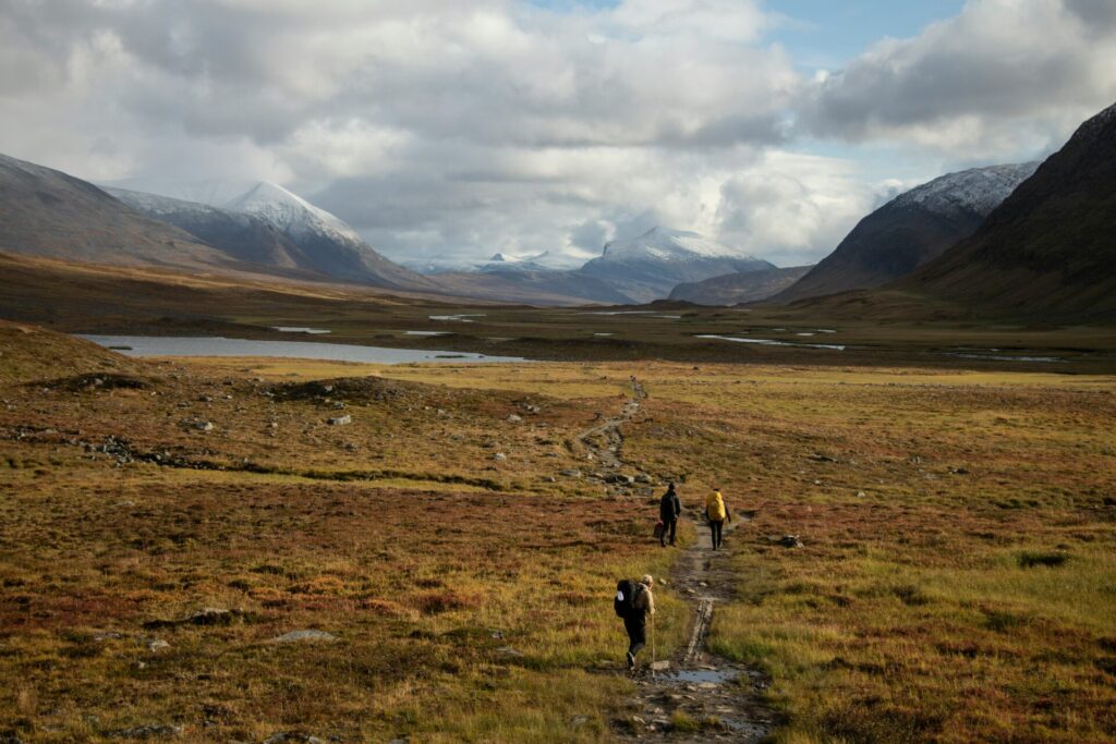 people walking on trail in mountains