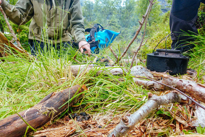 Setting up a campire by the fjord