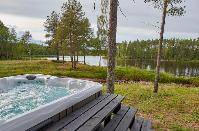 Enjoy an outdoor jacuzzi overlooking the river at an Arctic spa