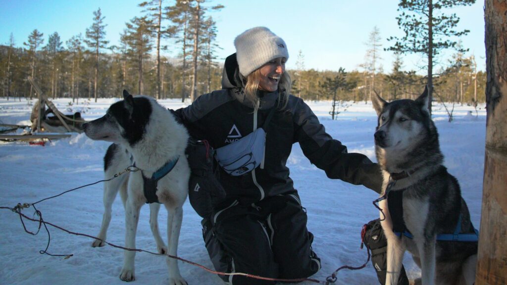 woman with huskies in the snow
