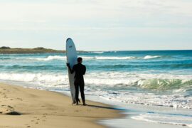 surfer by beach
