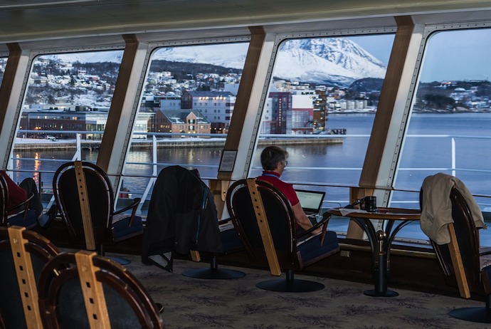 watching the scenery through panoramic windows on the MS Finnmarken