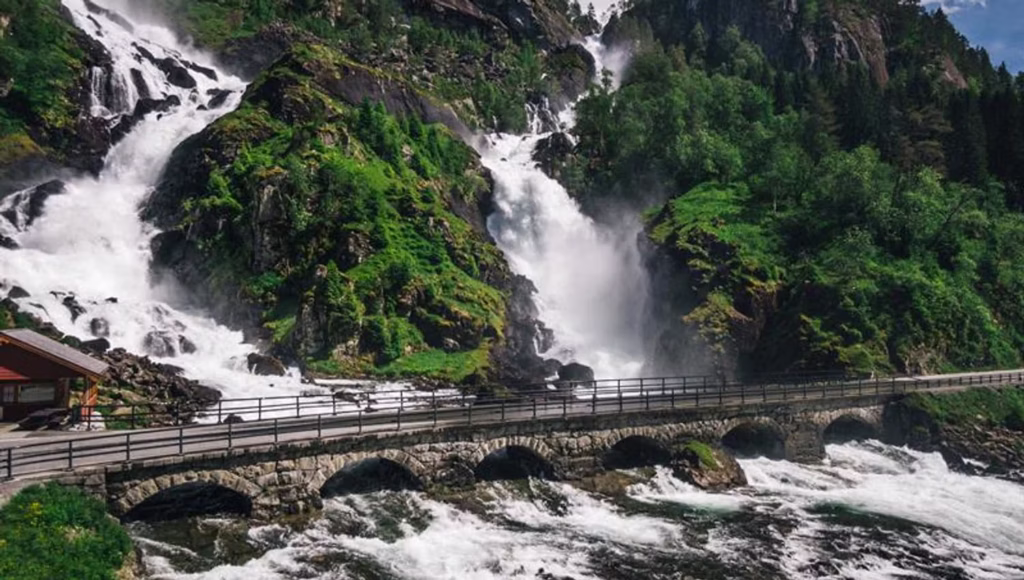 waterfall with road in front of it