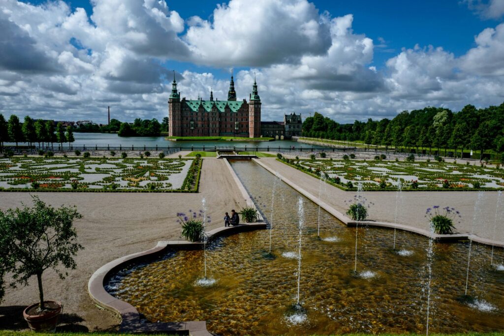 castle with gardens and fountains in front