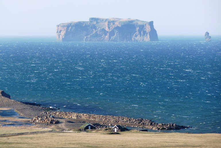 The Grettislaug hot pools look over the island of Drangey