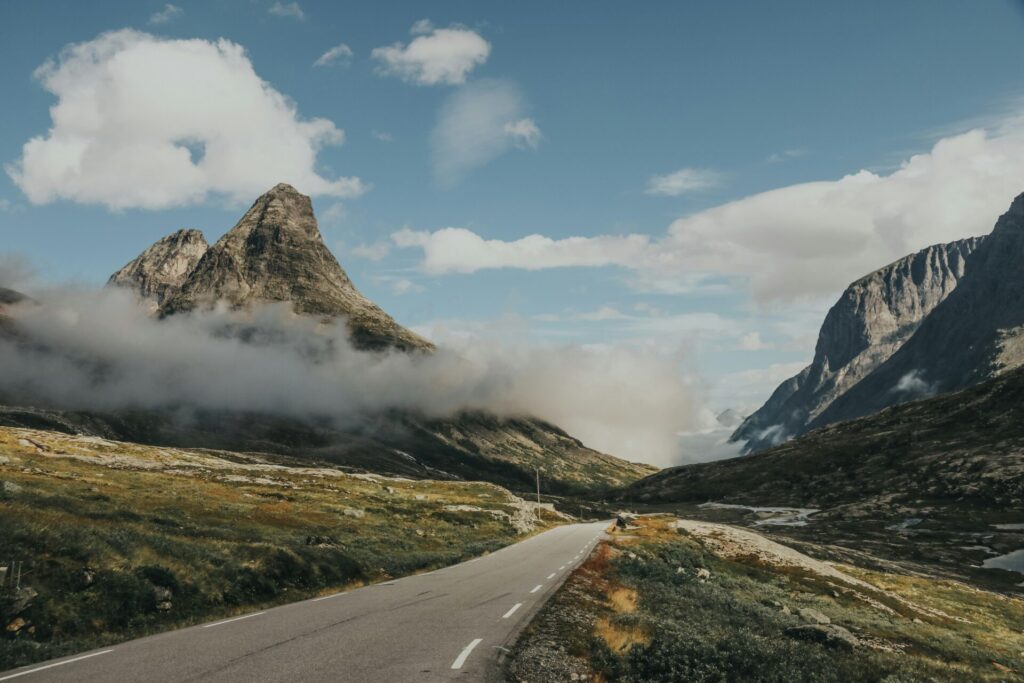 road in the mountains with clouds