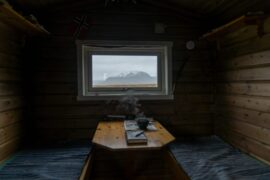 dark cabin with view and a book