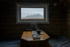 dark cabin with view and a book