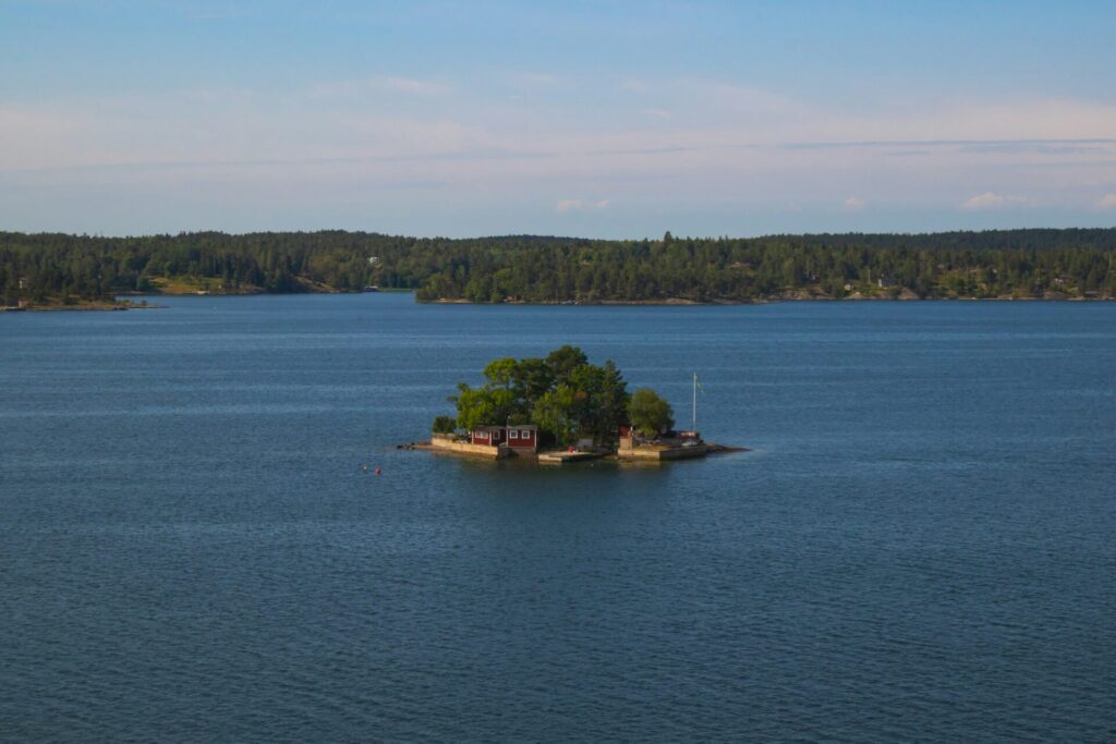 small island with red house in sea