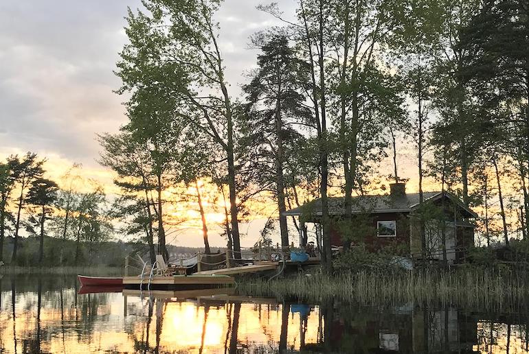 This wooden cabin sits on a private island in the middle of a lake in Finland.