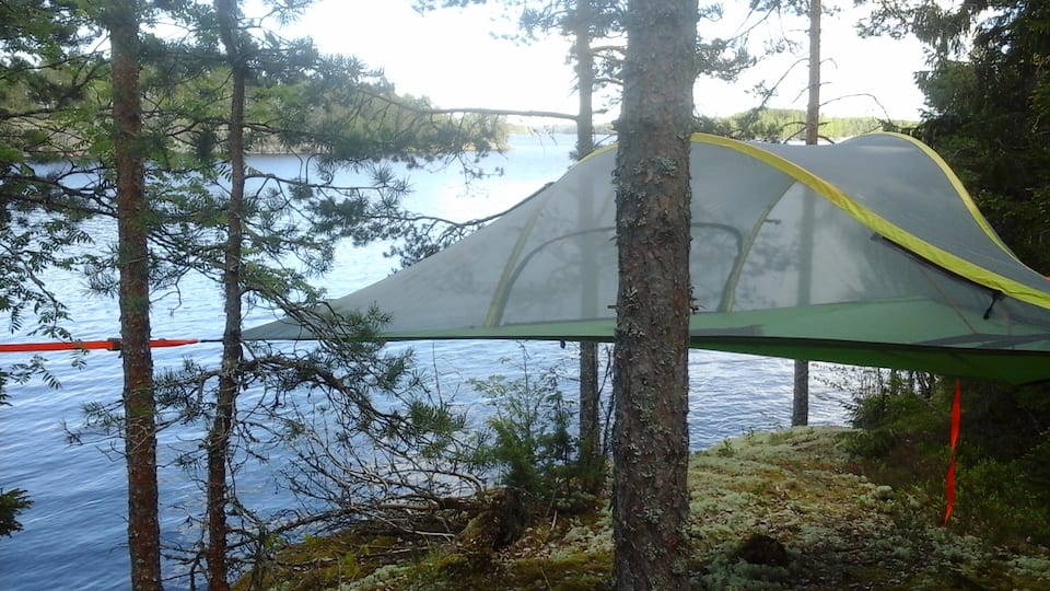 Hang out in a tent-in-a tree in the woods in Finland.