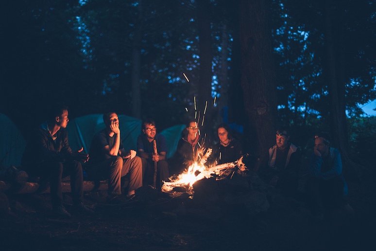 Dinner round a campfire with friends - what better way to embrace hygge with friends?