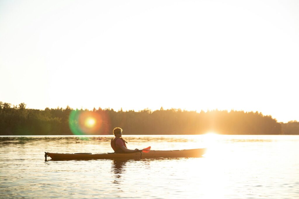 person on kayak at sunset
