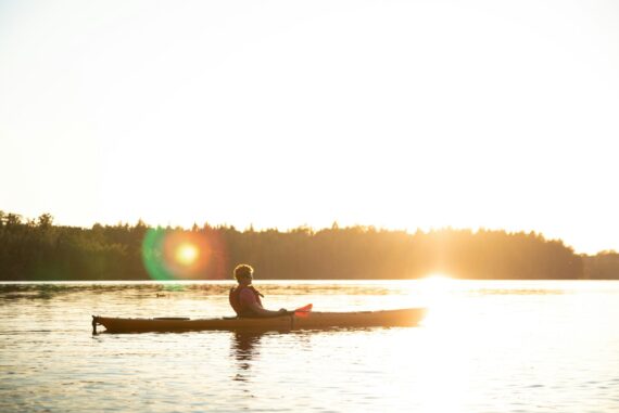 person on kayak at sunset
