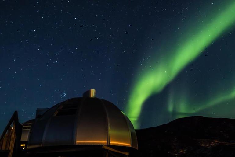 Watch the northern lights from an igloo in Greeenland