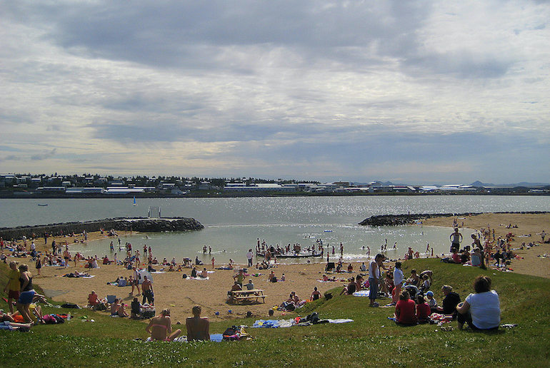 Nauthólsvík geothermal beach in Iceland has warm waters that you can swim in.