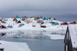 coloured houses on ice by the frozen sea in greenland