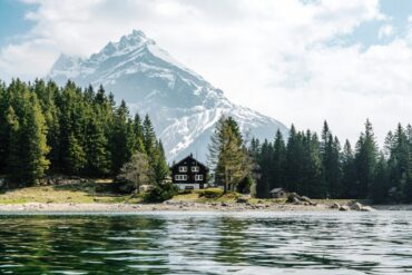 lake in front of a house and dramatic ice peaks