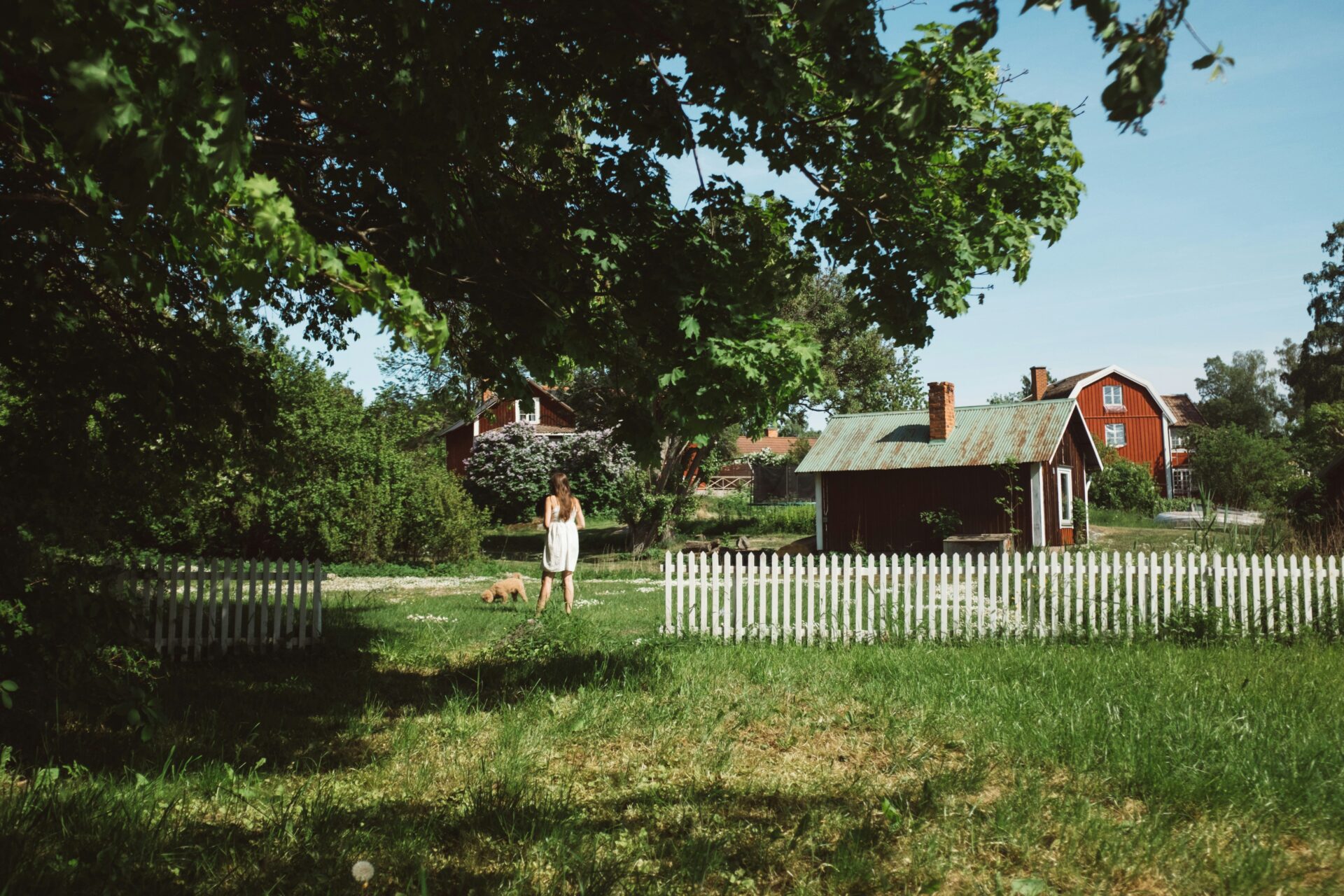 girl in sweden in front of red cabin
