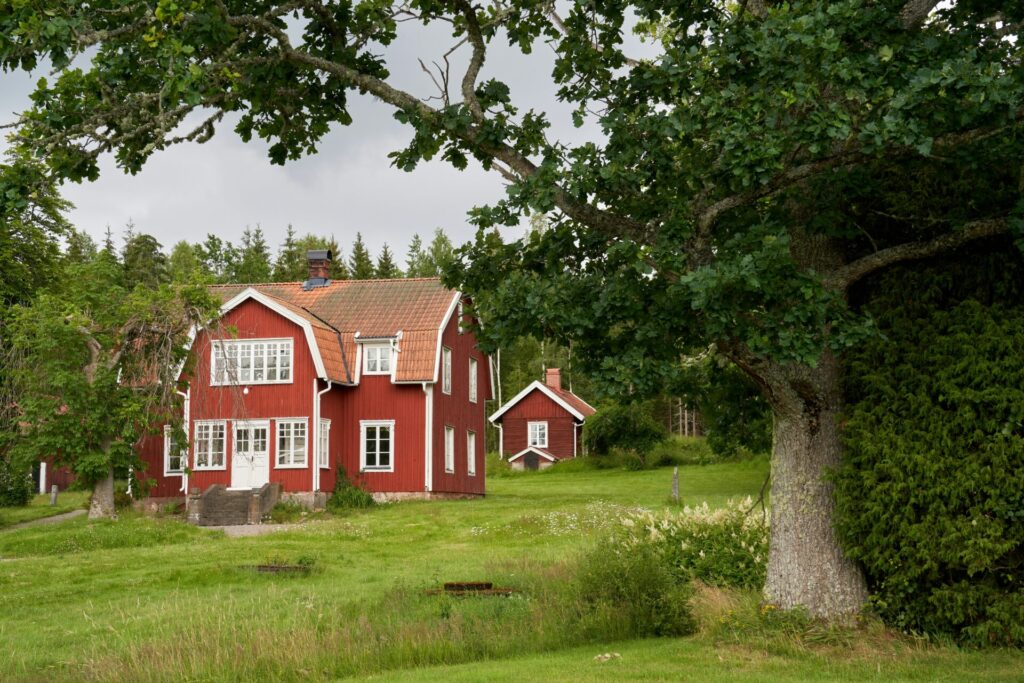 red cottage surrounded by trees
