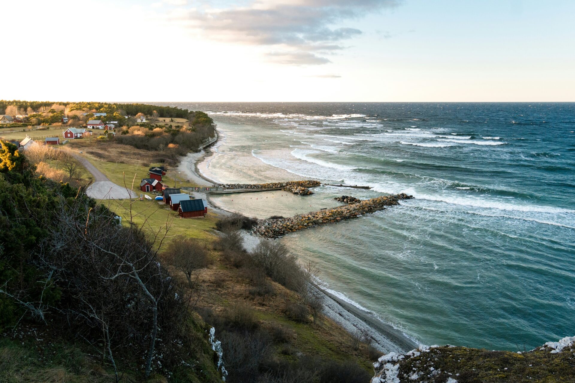 red cabins and fields by the coast