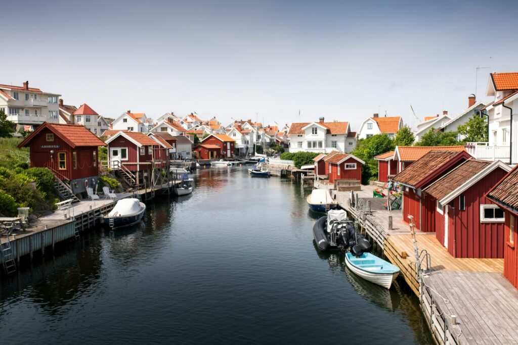 white and red houses by small river