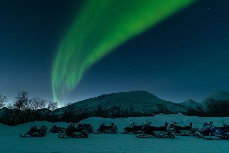 See the northern lights by snowmobile