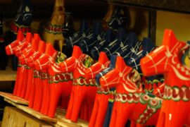 red wooden horses with drawings on them