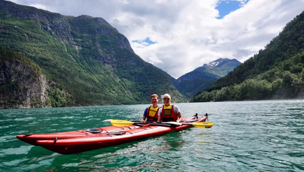 man and woman in kayaks in fjord