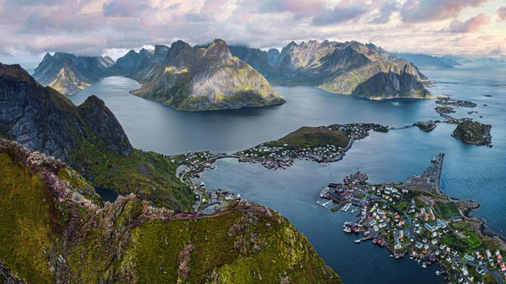 aerial view of fjord and mountains with small town