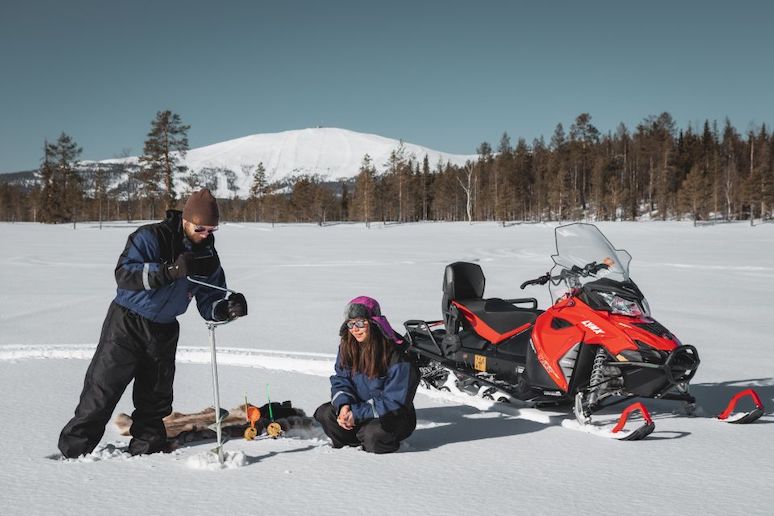 Learn the art of ice fishing by snowmobile in Levi, Finland