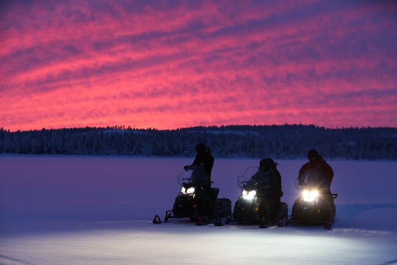You can take a sunset snowmobile tour from Levi, Finland.
