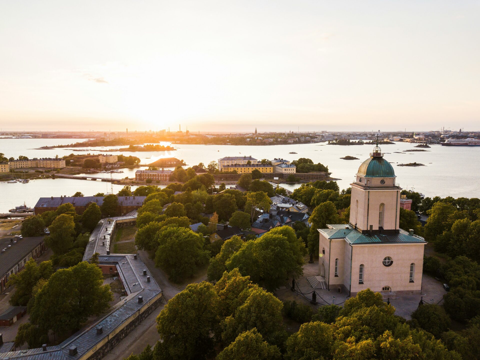 church surrounded by trees by the sea