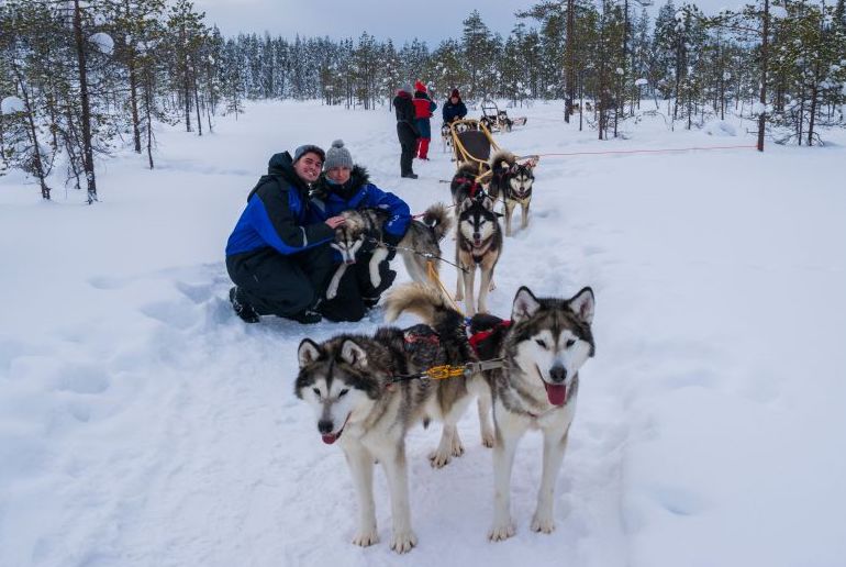 Combine dog sledding with a snowmobile tour in Rovaniemi in Finland.