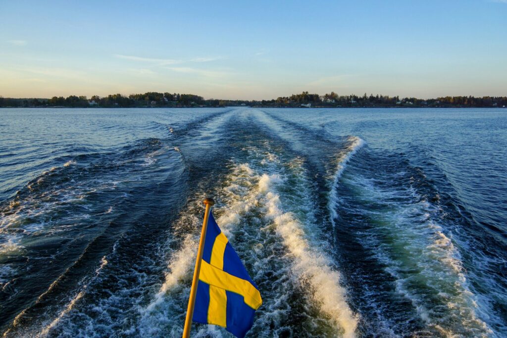 swedish flag in the back of a boat in sea