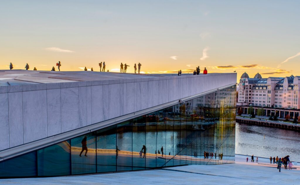 glass modern building at sunset by the water