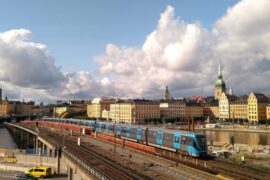 rails with blue train in old town stockholm