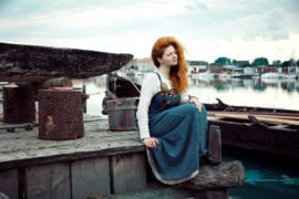 viking woman in dress on docks