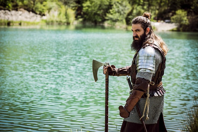 viking with axe standing by a lake