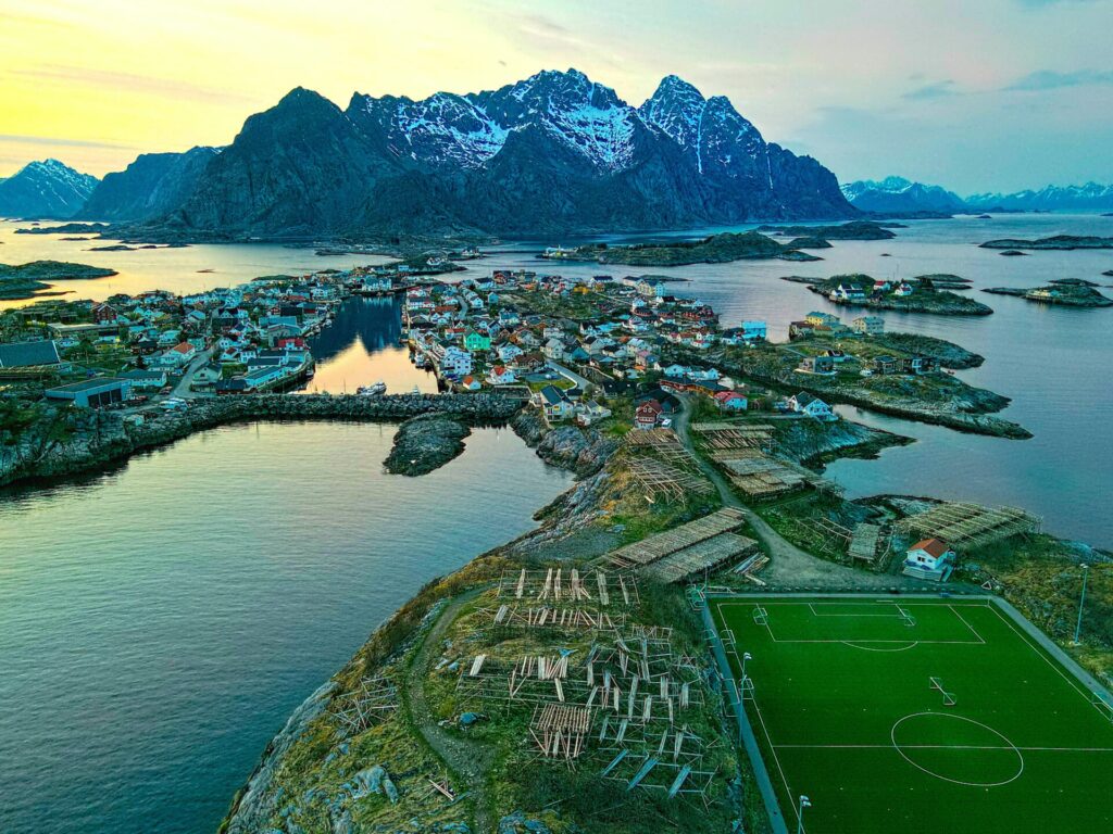 aerial view of soccer field and islands by the sea