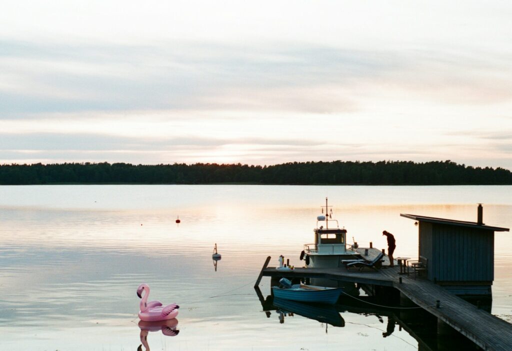 man standing on dock with sauna and flamino toy