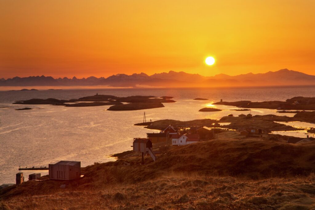 sunset over mountains by the sea