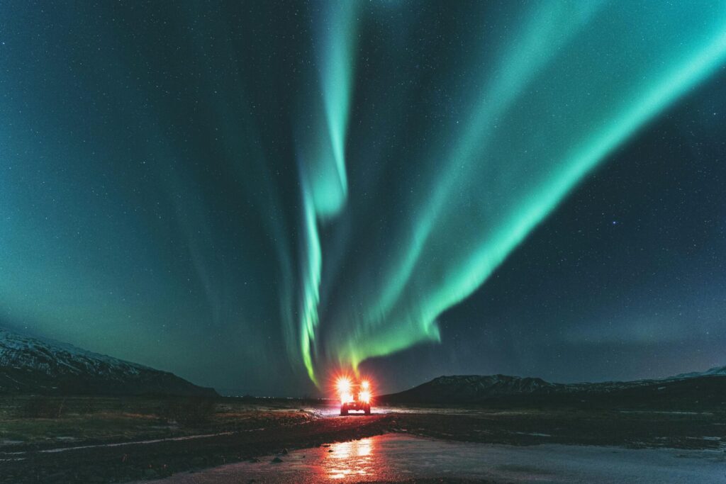 green northern lights with car