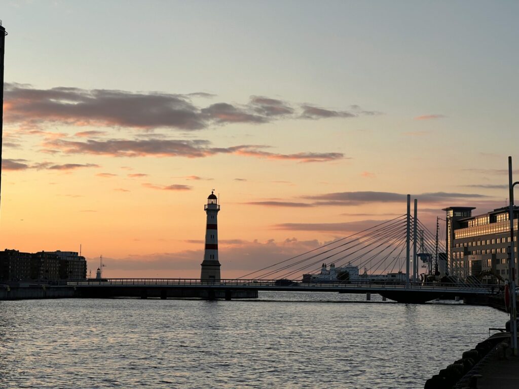 lighthouse by the sea at sunset