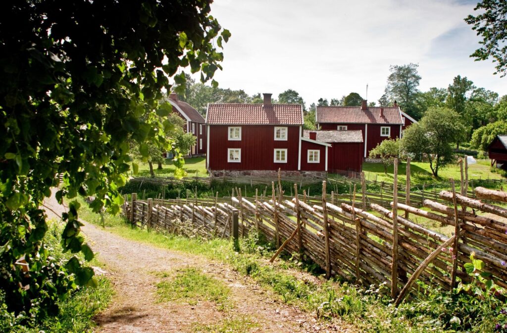 red wooden house with large garden