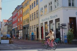 woman on bike in old city