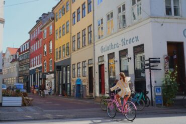 woman on bike in old city